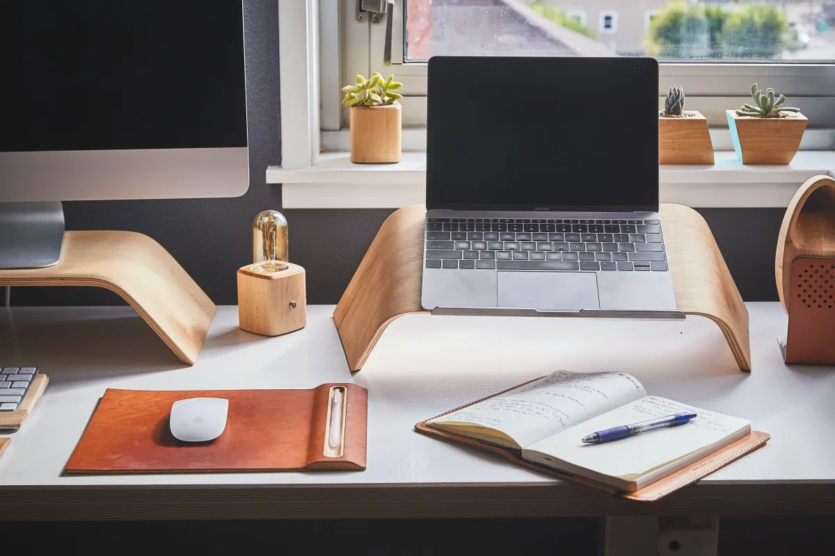 Desk with two computers and workspace from home office.