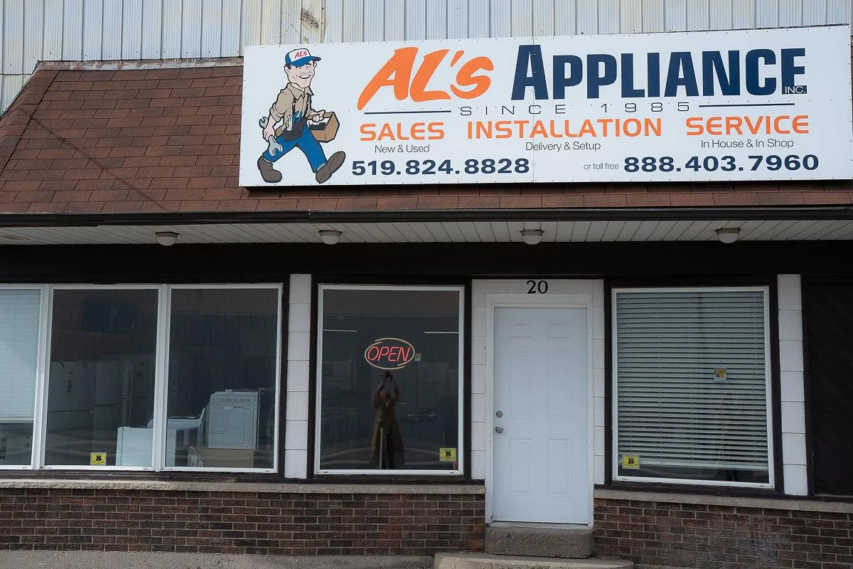 The storefront of Al's Appliance with the sign above the door.
