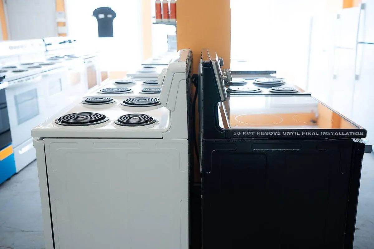 Al's Appliance Showroom with a variety of stove types on display.