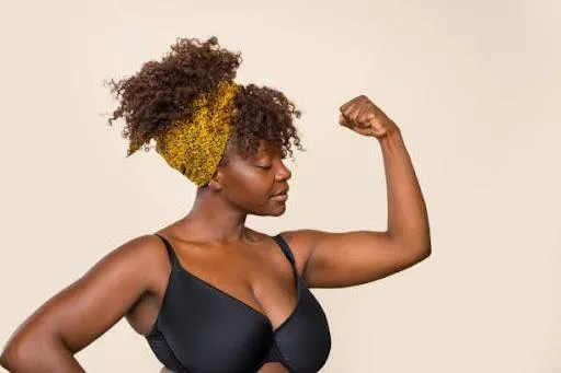 A confident plus-size woman embraces self-compassion mantras and body positivity, radiating strength and self-love - Stock photo.