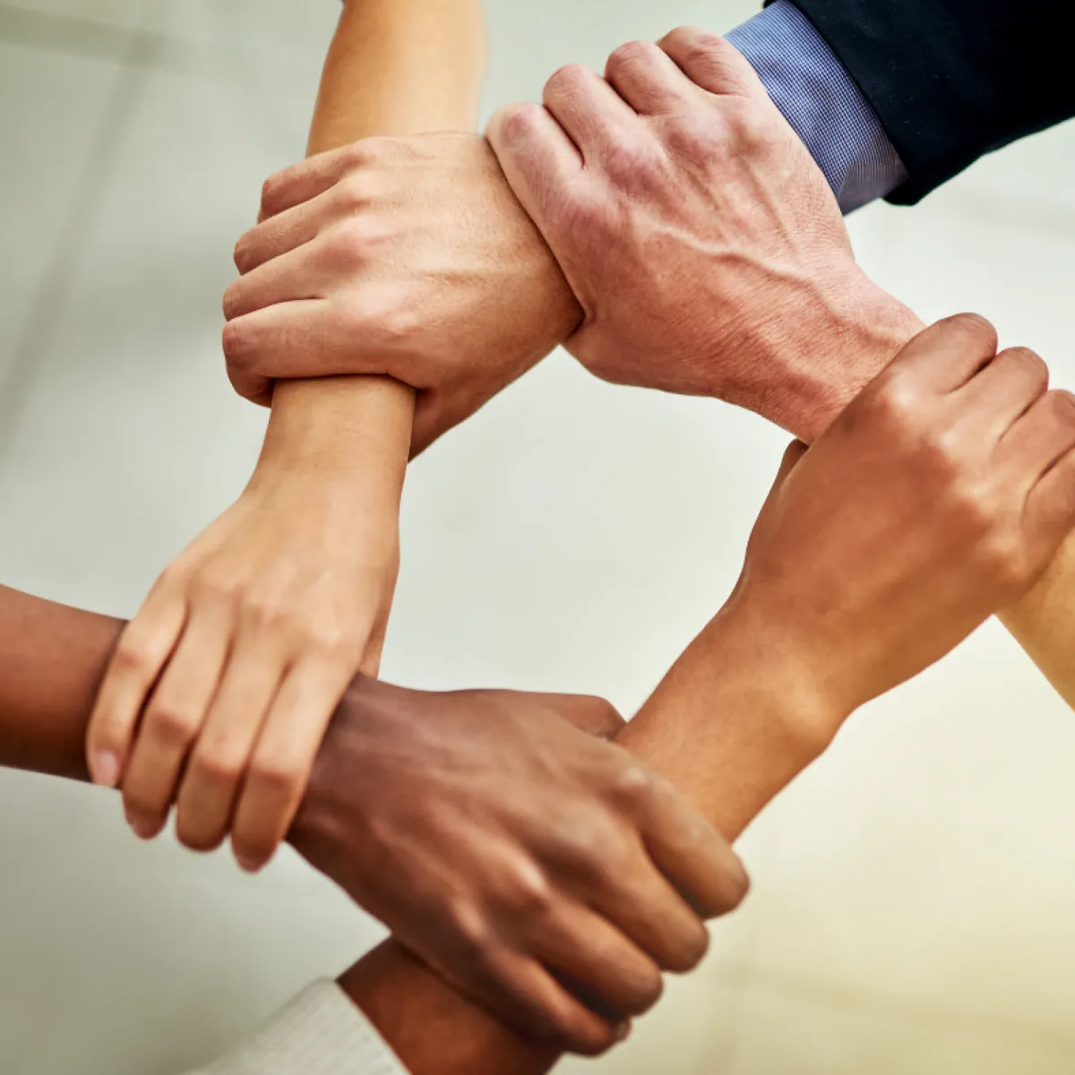 Hands joined in solidarity, symbolising connection and shared strengths in restorative school problem‑solving.