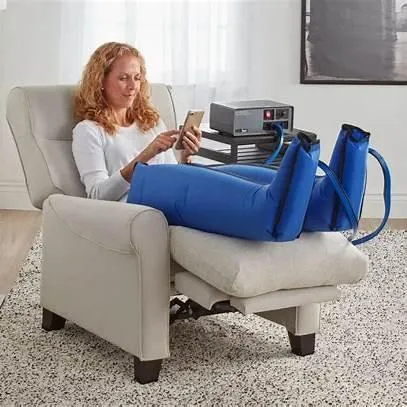 Patient receiving at-home treatment using a pneumatic compression device with leg sleeves to reduce swelling and improve circulation—MCB DME equipment for lymphedema and vascular therapy in New Jersey.