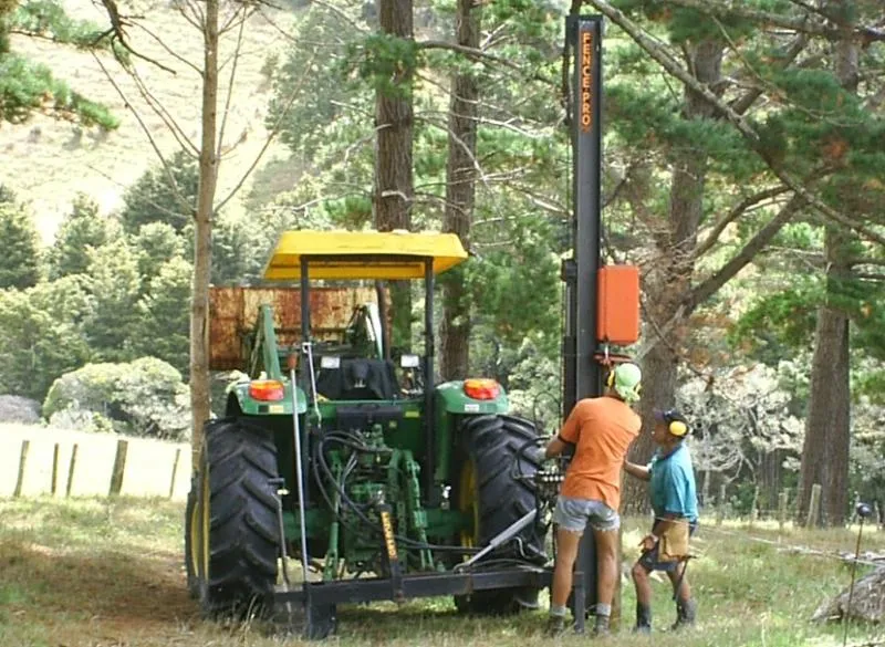 tractor with side mounted post rammer