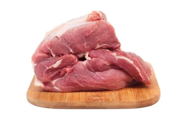 a heap of raw meat on a wooden board