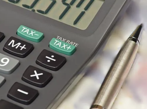 calculator and pen on a desk
