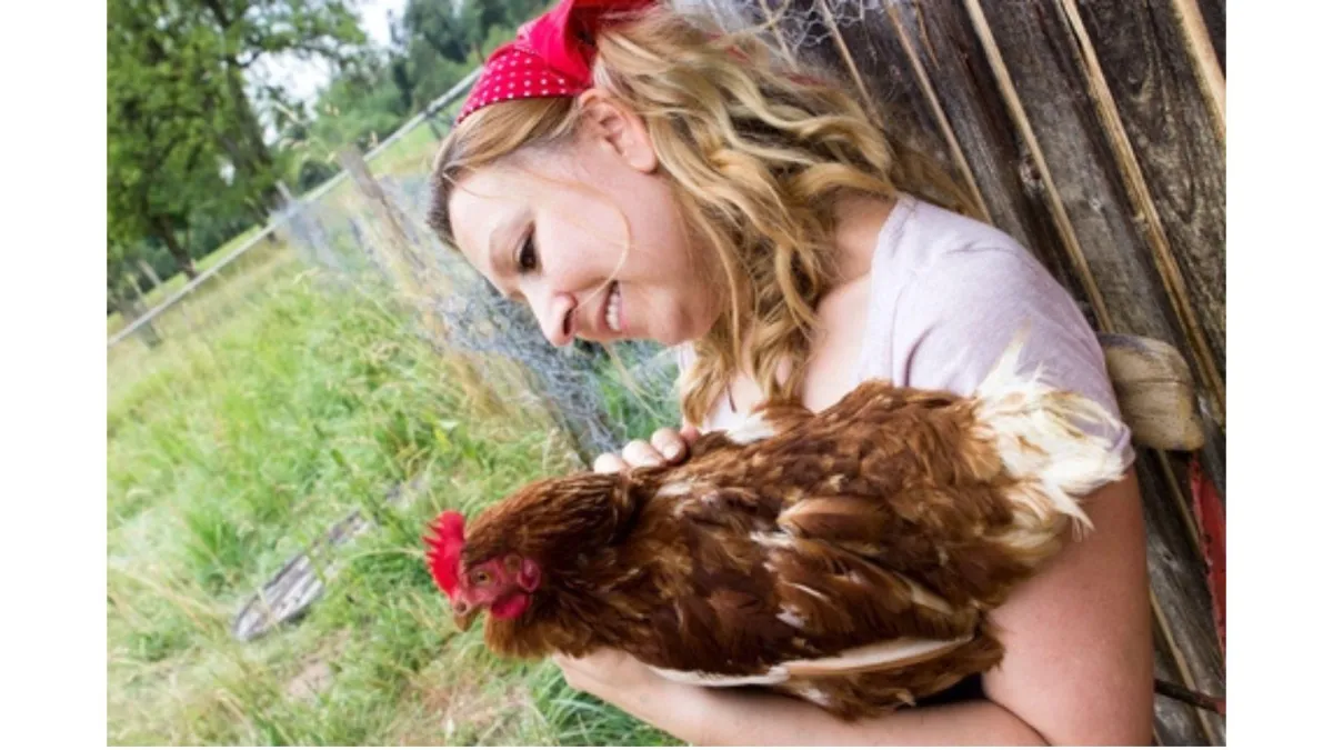 Farmer holding a hen
