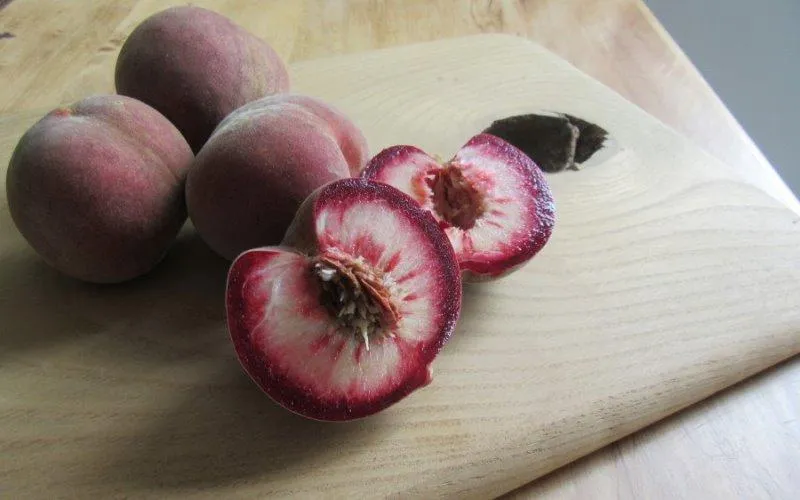 sanguine peaches on a wooden board