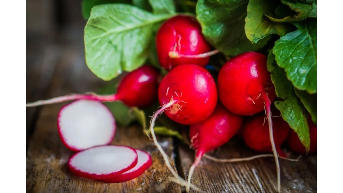whole and sliced radishes on a board