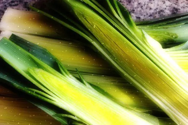 a leek cut lengthwise on a board