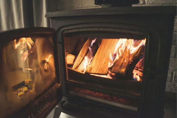 Wood burner with open door, used for heating a lifestyle block home.