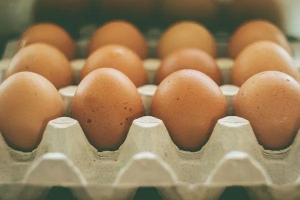 an egg carton with eggs ready for sale