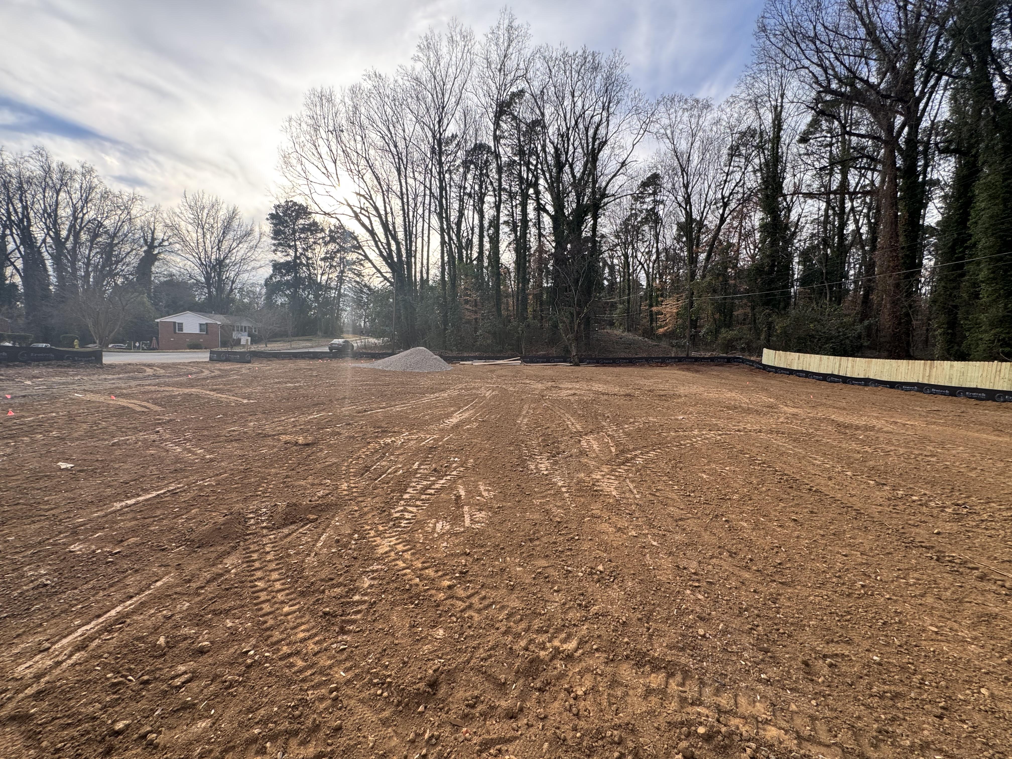 Early-stage construction of a two-story five-bedroom brick home near a lake in Concord, North Carolina, built by Neta Homes as a custom residential project.