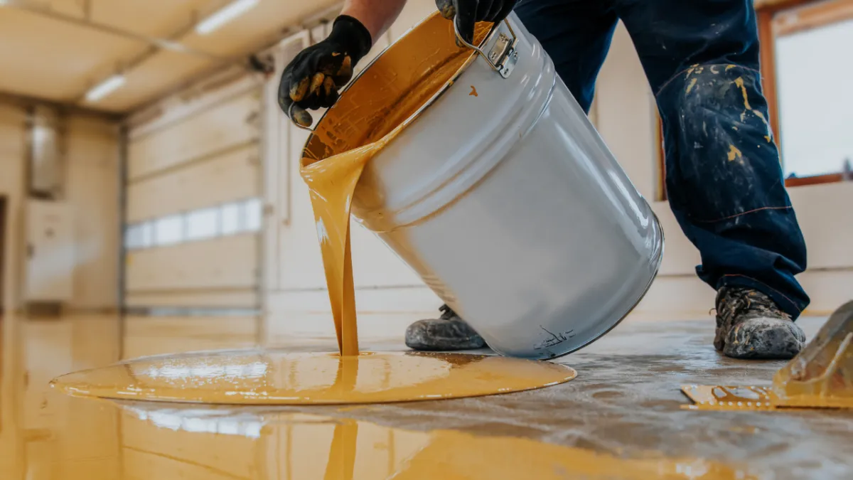 "Glossy epoxy garage floor with tools and parked vehicle showcasing durability, easy maintenance, and modern aesthetic appeal"