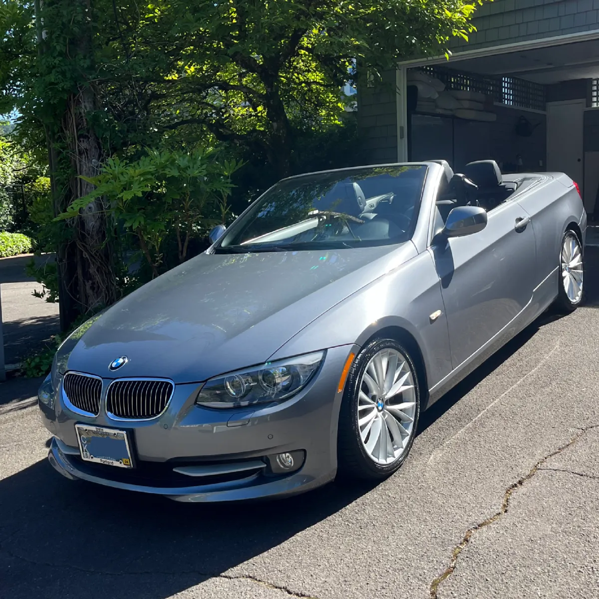Silver BMW freshly detailed on residential street