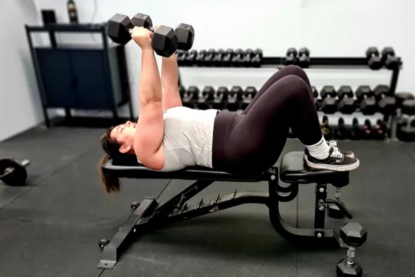 busy mum lifting weights and exercising