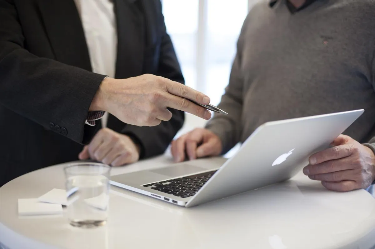 two people reviewing a contract on an ipad