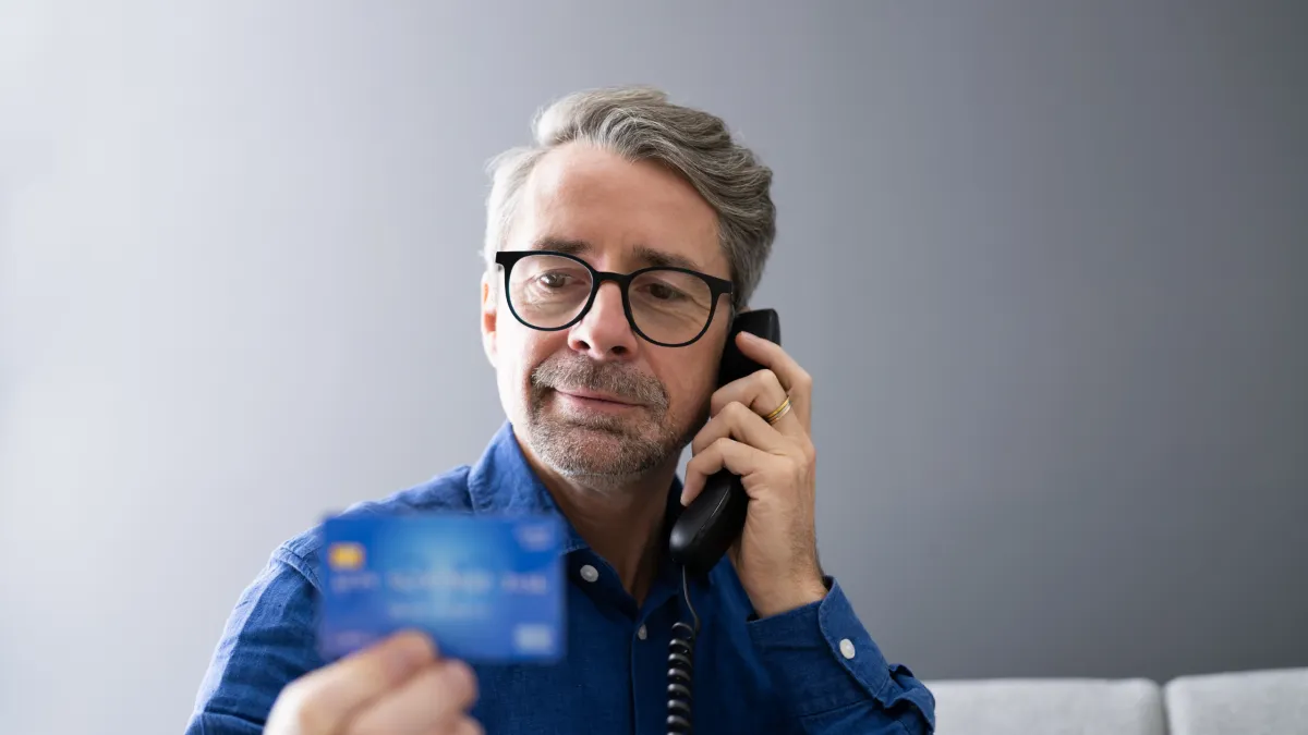Veteran calling and holding a card