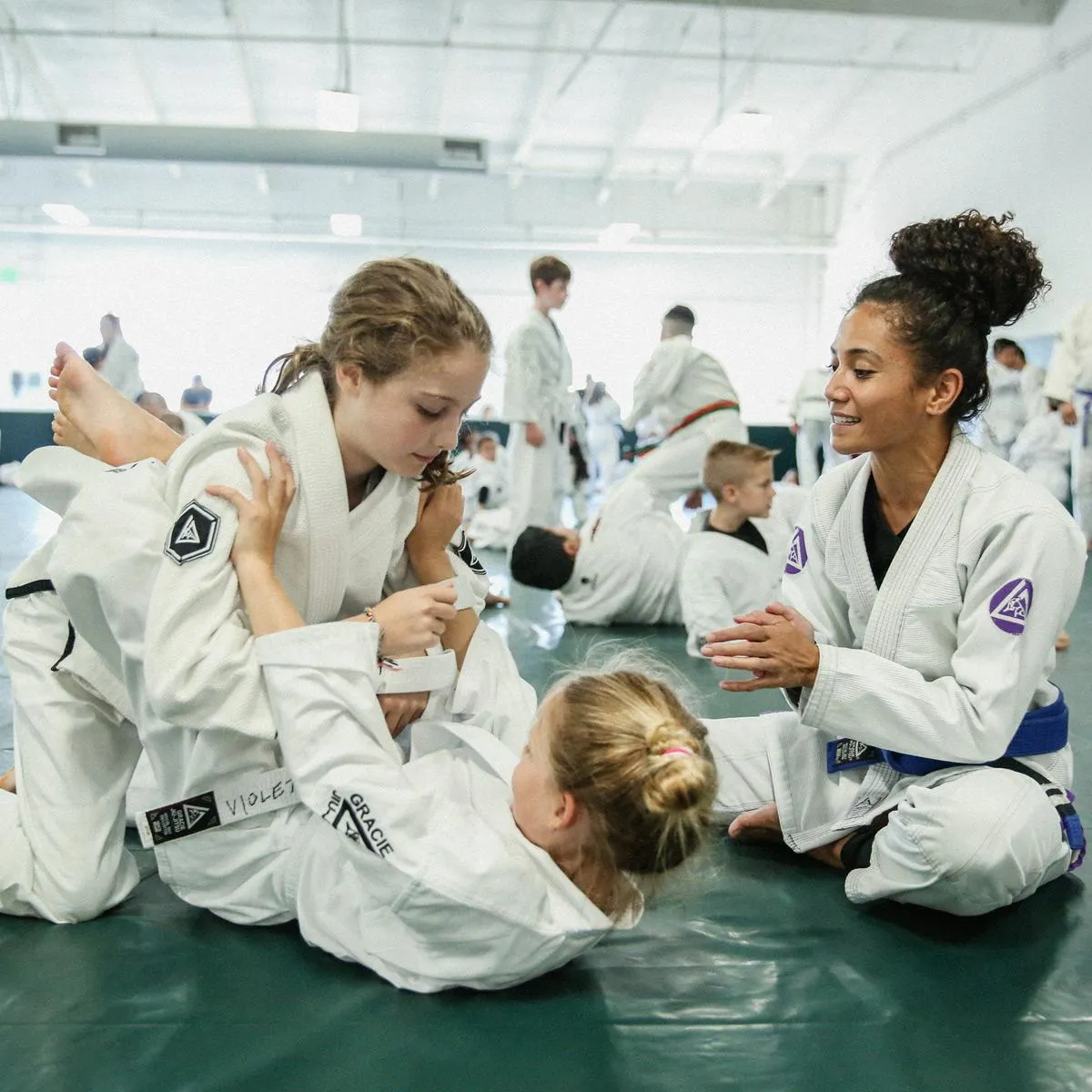 A certified instructor helping two bullyproof students