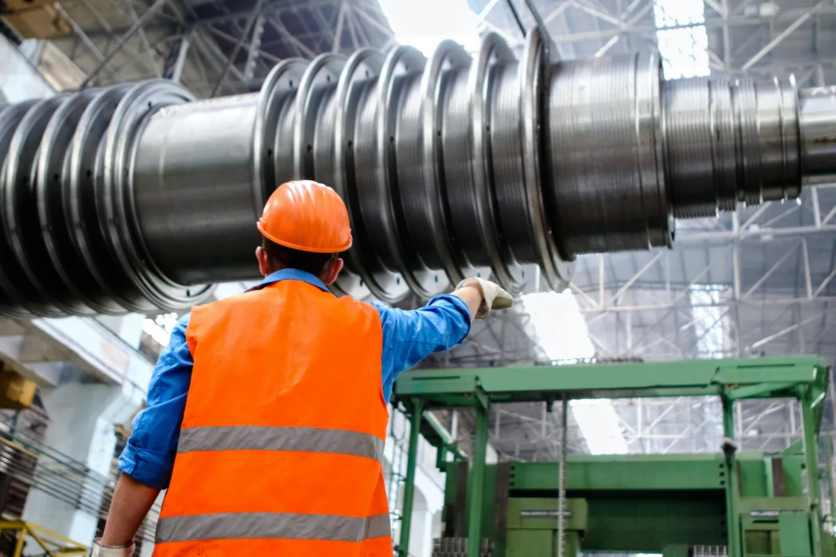 worker in front of metal coil stock image