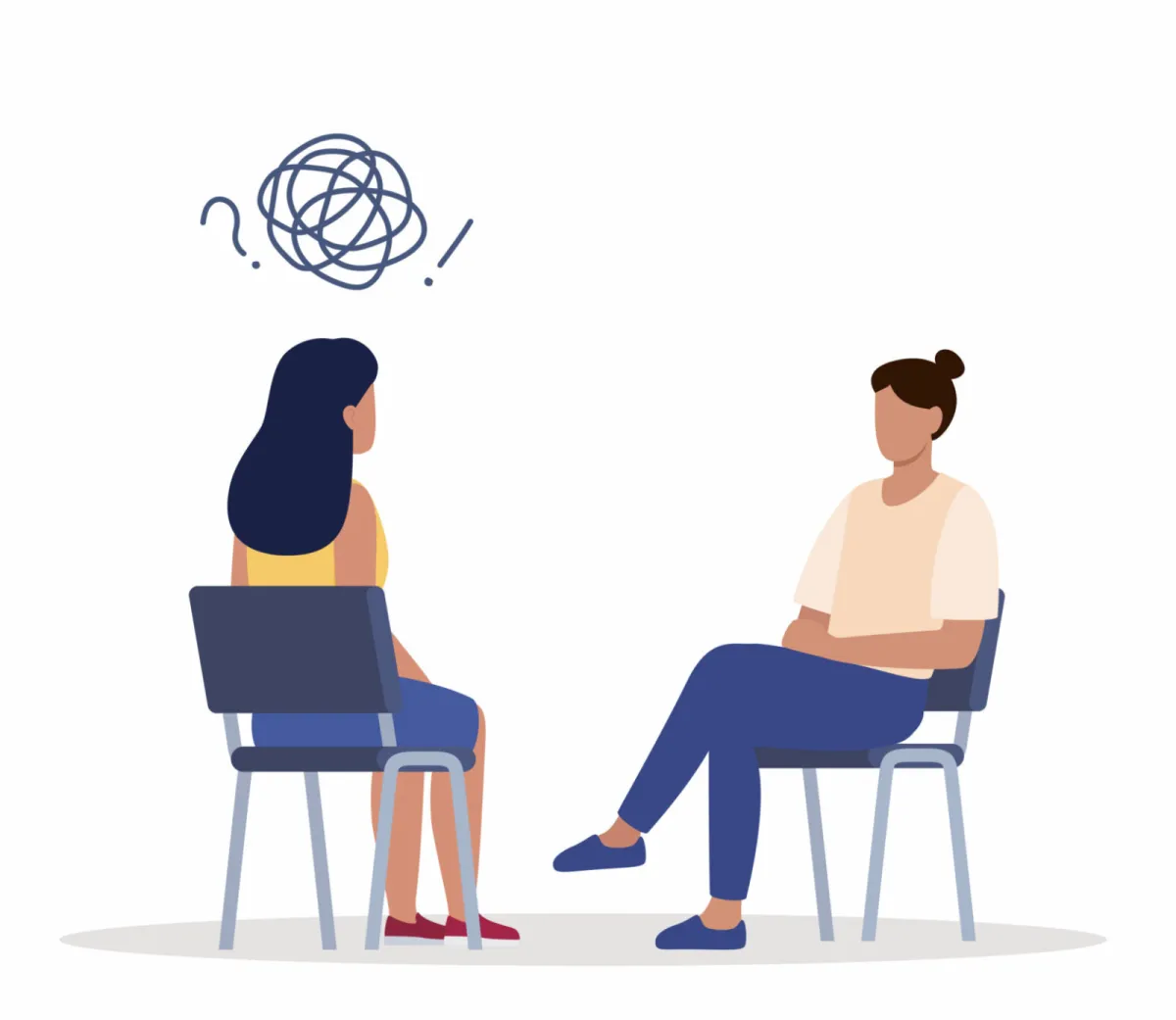 Therapist and client sitting in chairs talking during a counseling session