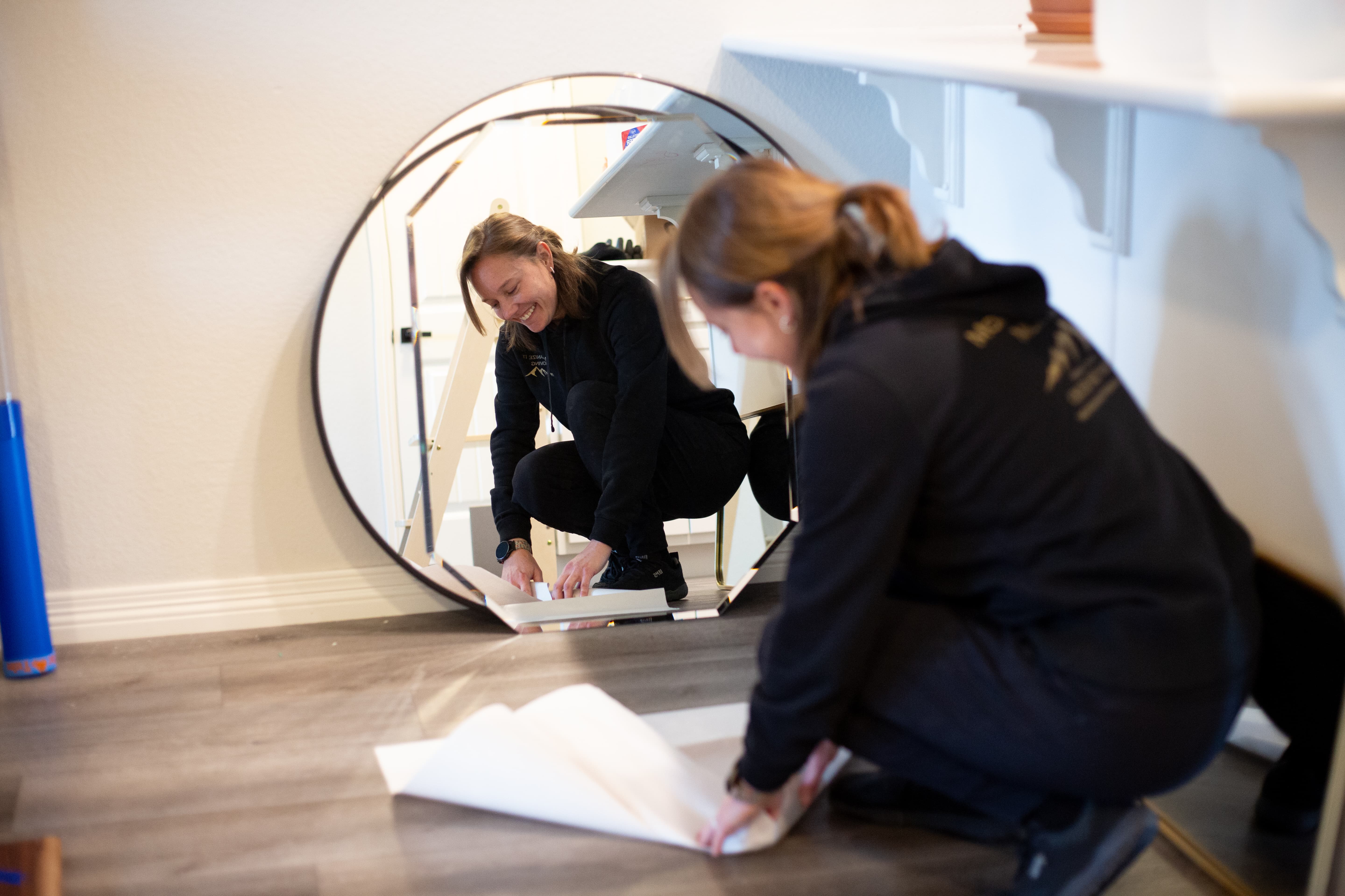 Morgan is wrapping a delicate mirror for transport