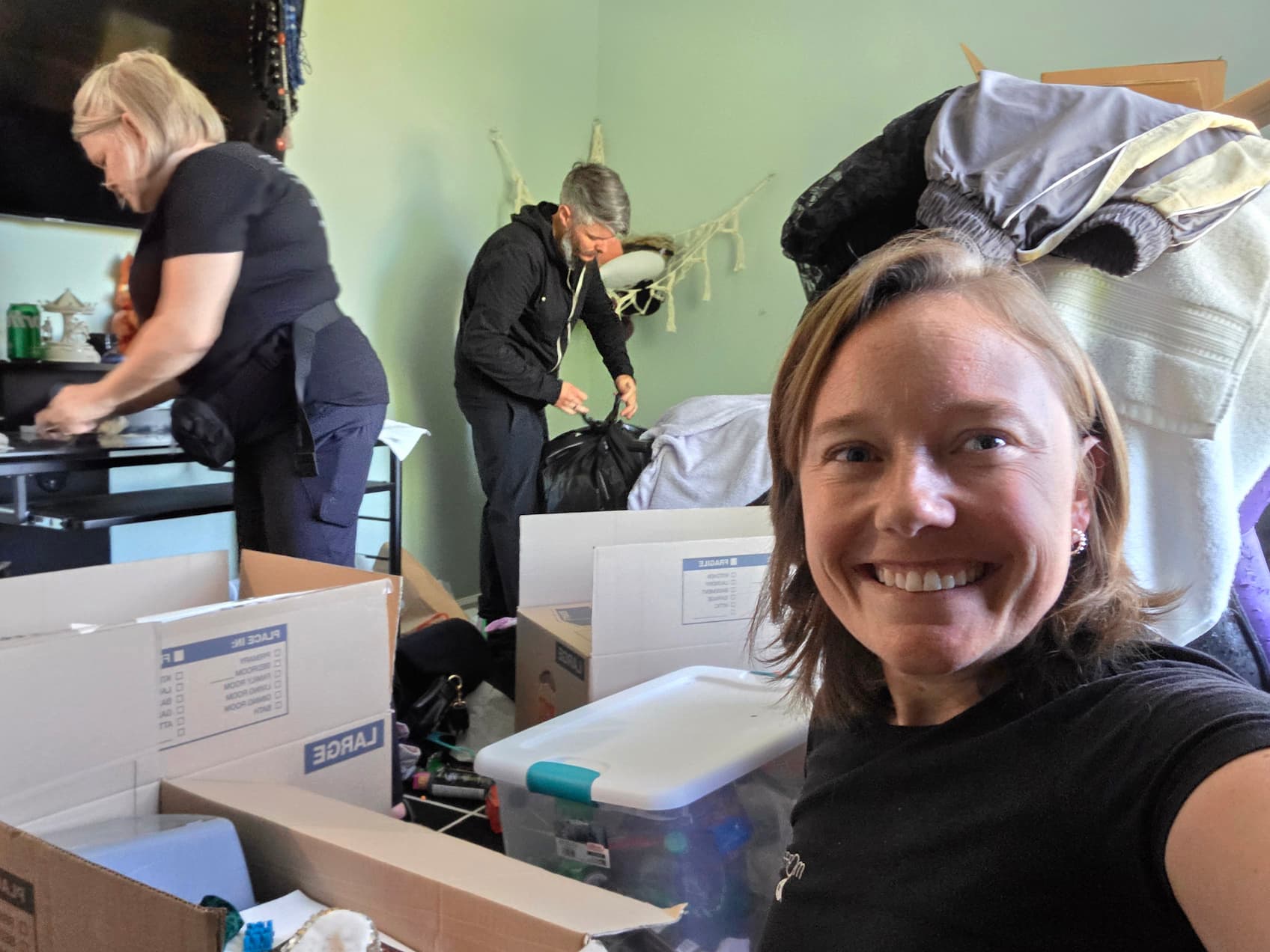 Professional organizer managing a home move with organized packing, labeled boxes, and decluttering in progress.