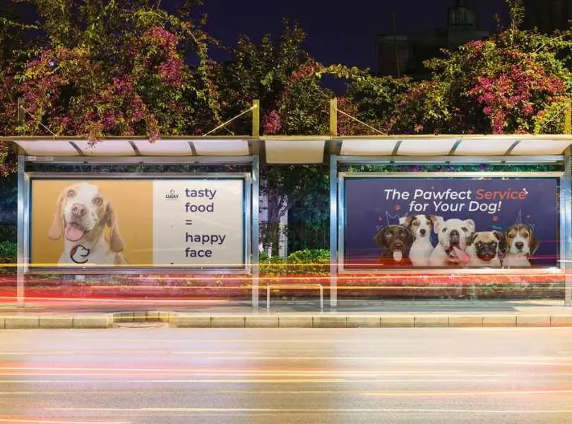 A bus stop featuring two large billboards advertising various products or services.