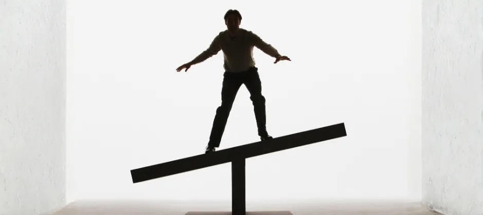 Man standing on a balance scale