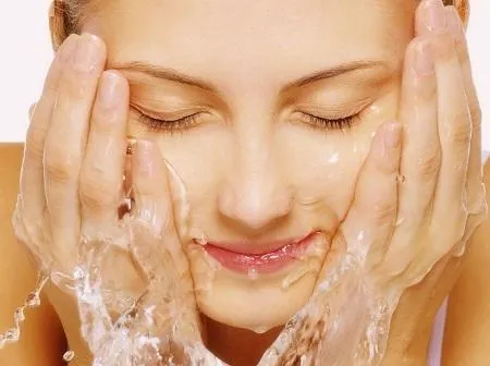Woman washing her face