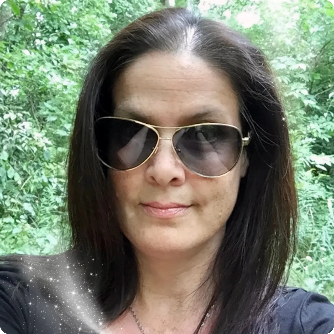 Portrait of woman wearing sunglasses standing in a forest