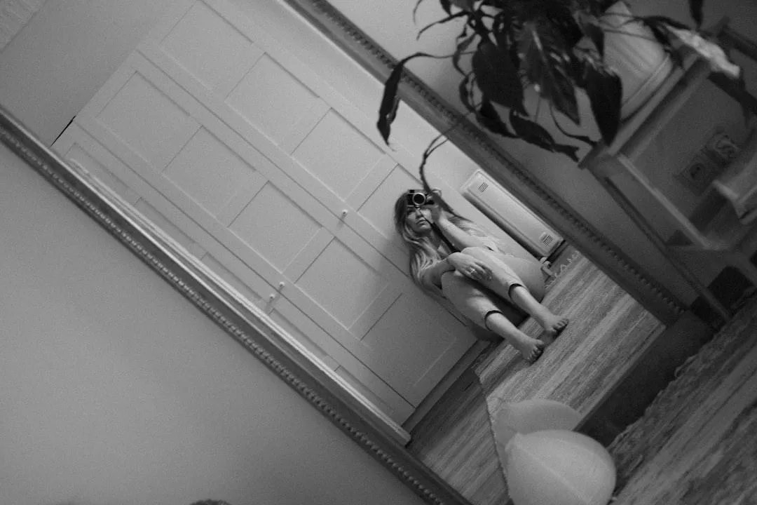 woman taking photo of herself in a mirror