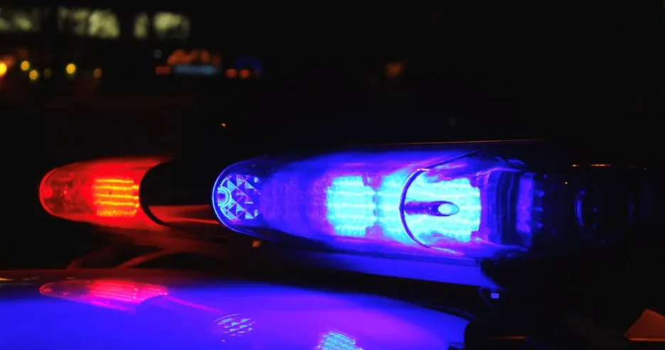 Police lights flashing at night, highlighting the danger of drowsy driving caused by untreated sleep apnea.