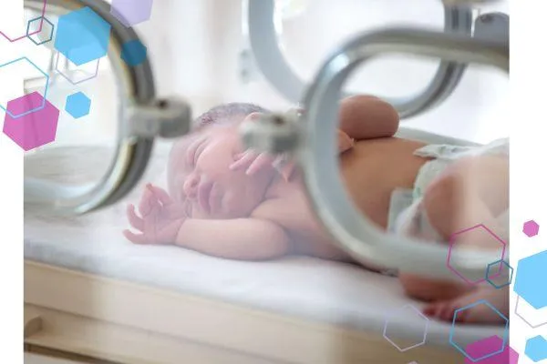 A baby lying in an incubator on the neonatal care ward