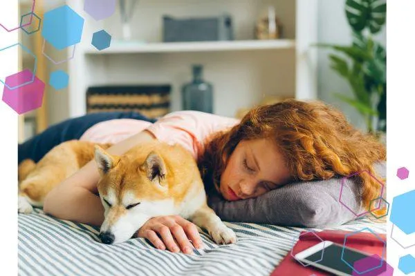 A pregnant person resting on a bed beside their dog, showing the real fatigue and emotional intensity of early pregnancy. Image used for CubCare’s first trimester antenatal support blog.