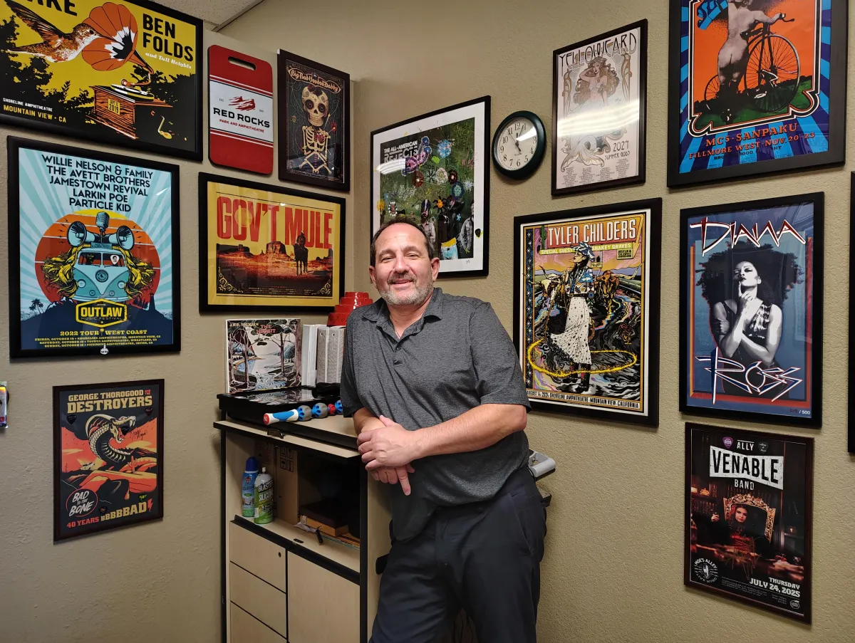 Dr. Bourget standing in front of his Art Collection