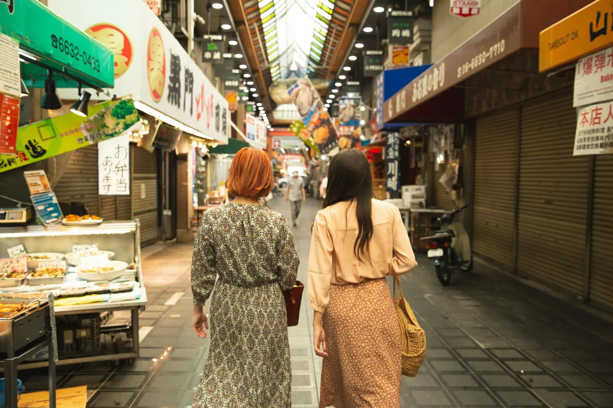 Women walking down a line of shops