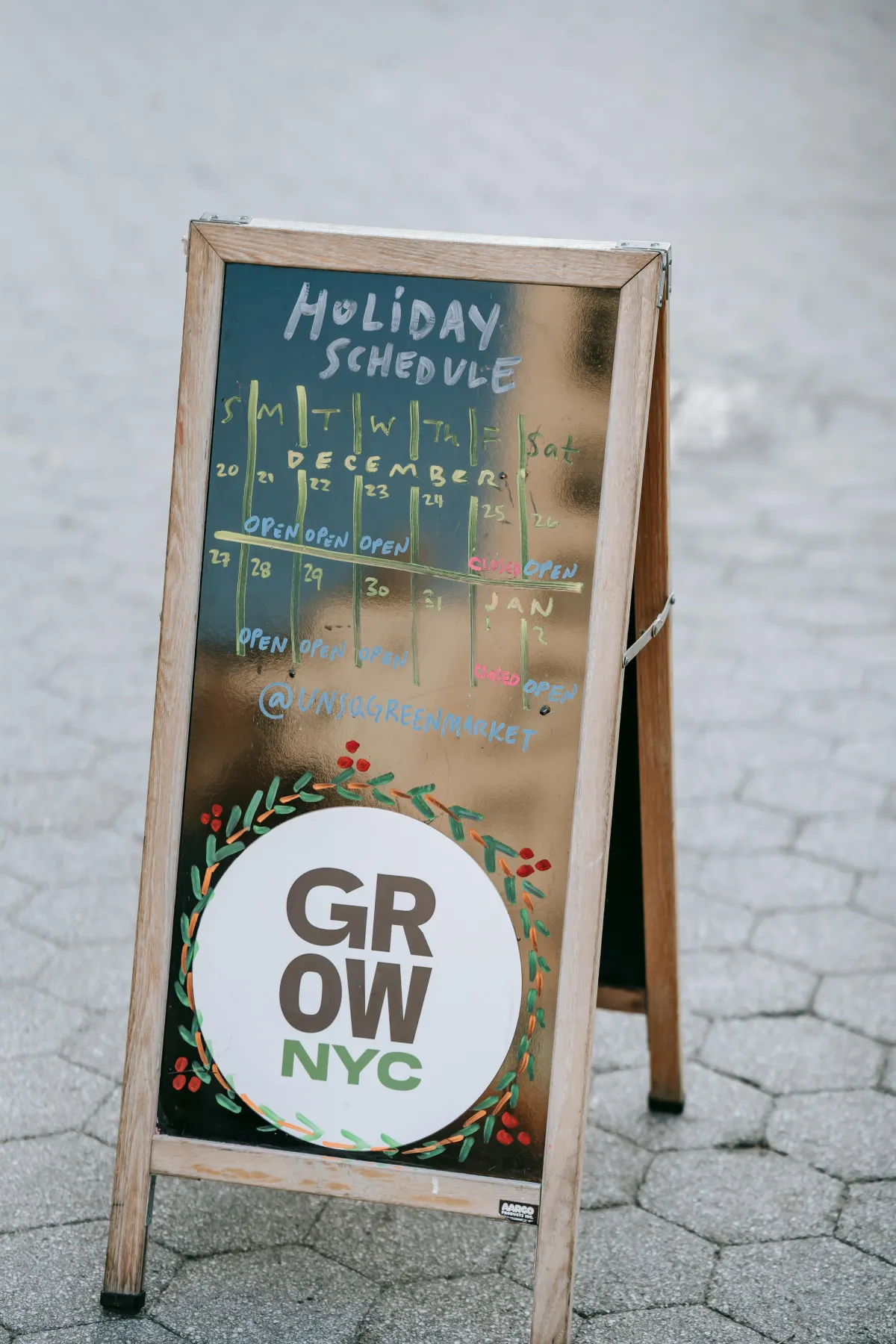 A outdoor sign with a calendar of hours
