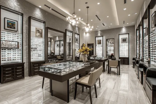Luxury optical boutique interior showcasing high-end eyewear with professional lighting and elegant California design