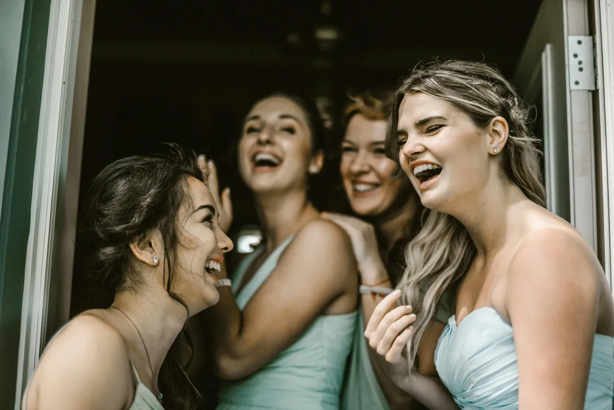 Bride and Bridesmaids laughing