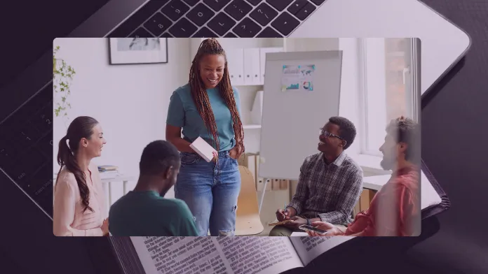 African woman confidently speaking to a small group, with a laptop and Bible in the background symbolizing her faith-driven online mission.