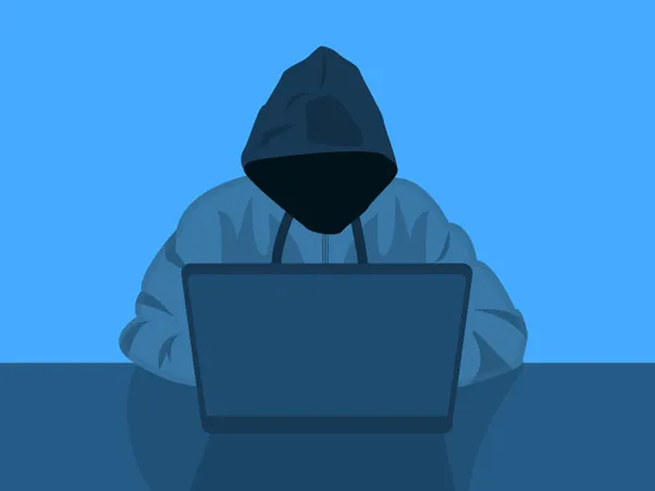 hooded hacker at computer hacking