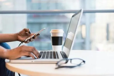 employee working at table with phone