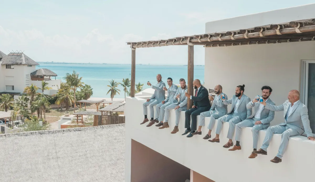 A Groom and his Groomsmen at a destination mexico wedding in grey and light blue suits