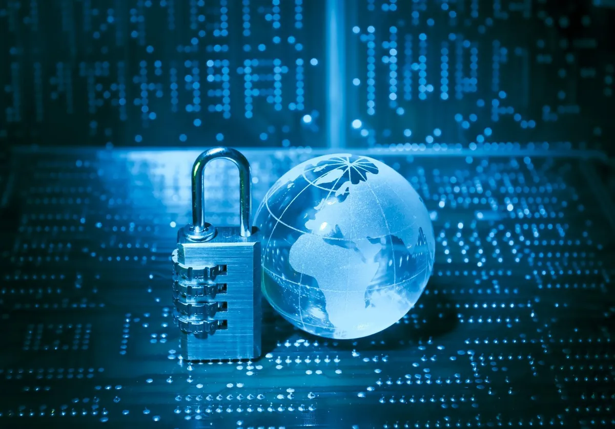 A lock and a small earth sitting on a circuit board.