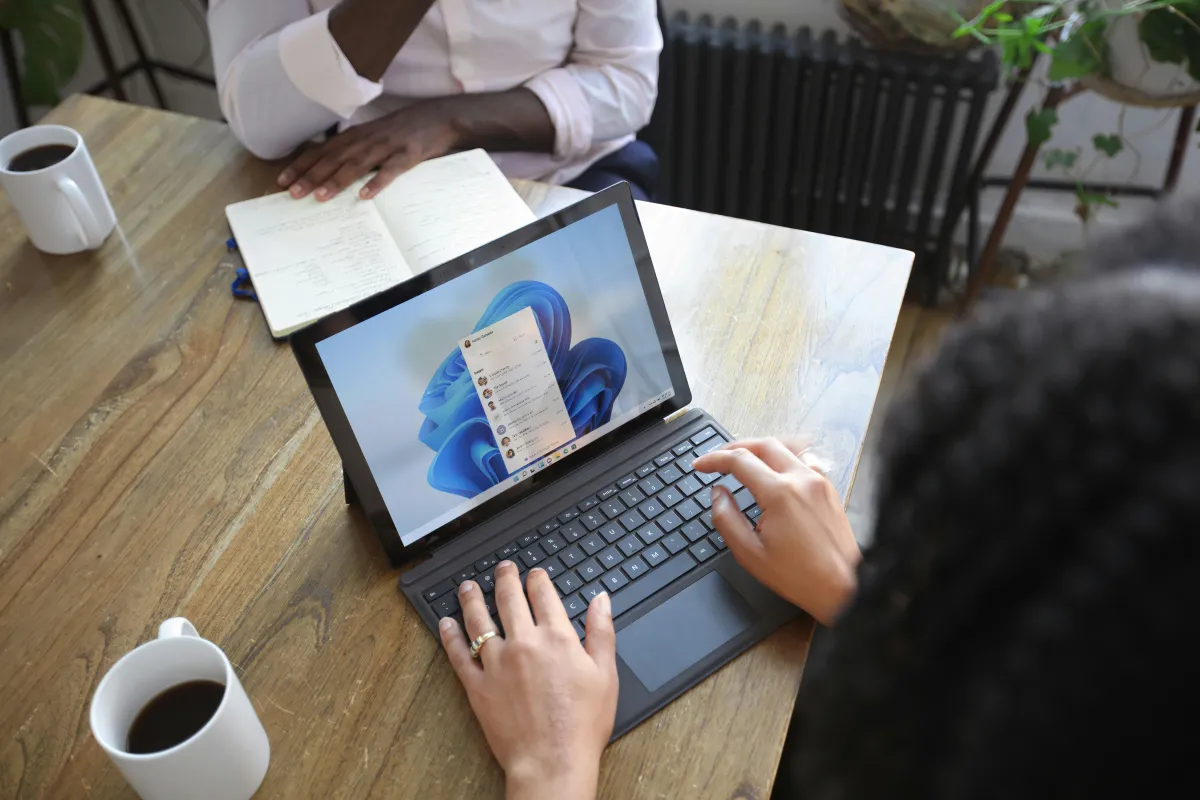 a person typing on a laptop.
