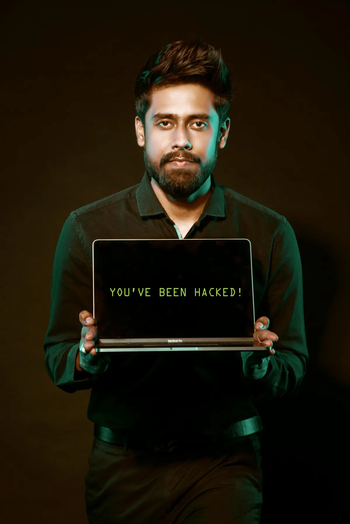 A man holding a laptop with both his hands.