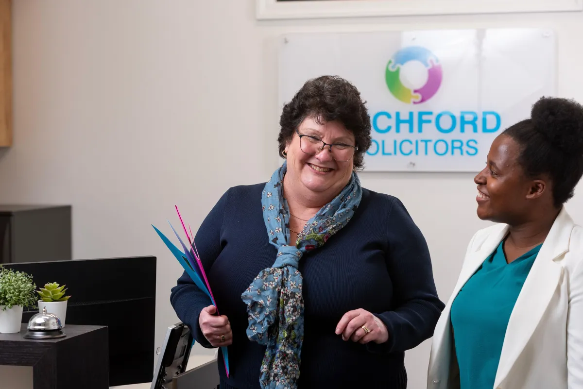 Leila and Riziki smiling together, representing clients supported by Rochford Solicitors for migration and visa matters in Toowoomba and the Darling Downs.