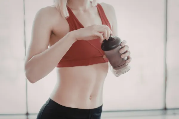 Post-workout protein shake next to Grip Hydra water bottle