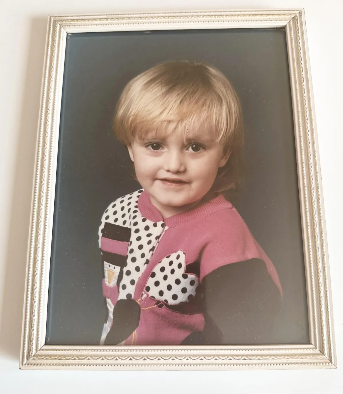 A school photo of a young blonde girl