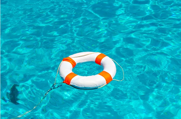 Life ring floating on water, metaphor for safeguarding a coaching business from procrastination and self-sabotage.